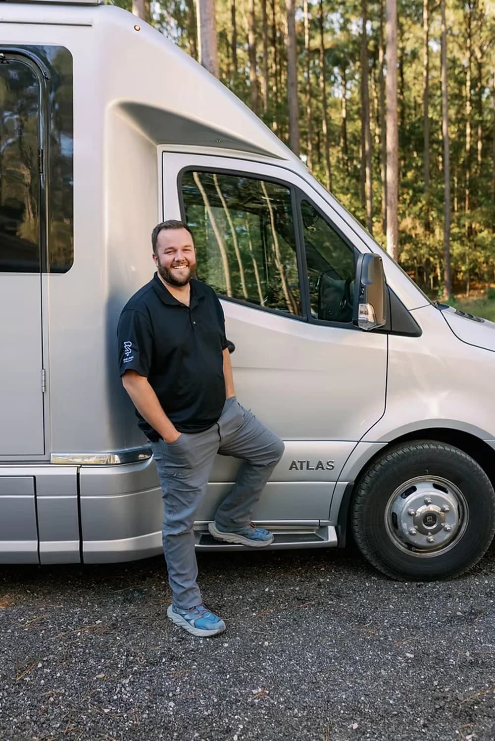 Tate Erwin, owner of Rinse & Shine RV, standing next to an Atlas motorhome